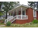 Brick home with a wraparound porch and white railings at 212 Pethel St, Kannapolis, NC 28081