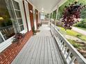 Spacious front porch with white railing and hanging plants at 212 Pethel St, Kannapolis, NC 28081
