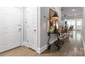 Inviting entryway with wood floors, decorative table and view into the living area at 5916 Bridger Ct, Charlotte, NC 28211