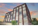 Brick building exterior with many windows at sunset at 715 N Graham St # 201, Charlotte, NC 28202