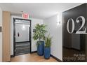Building hallway with plants and modern decor at 715 N Graham St # 201, Charlotte, NC 28202
