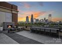Relaxing rooftop terrace with city views, fireplace, and seating at 715 N Graham St # 201, Charlotte, NC 28202