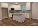 Modern kitchen featuring white cabinets, granite countertops, and stainless steel appliances at 318 Lewis Ferry Rd, Statesville, NC 28677