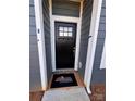 Stylish black front door with glass panes and gray siding creates curb appeal at 4077 Port Richmond Ave # 18, Gastonia, NC 28056