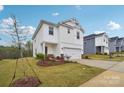 Attractive two-story home with a lush lawn and a driveway leading to a garage at 203 Alden Ct, Shelby, NC 28152