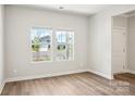 Bright living room featuring hardwood floors and large windows offering neighborhood views at 153 Shepherds Landing Dr, Mooresville, NC 28115