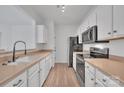 Modern kitchen featuring stainless steel appliances and light wood cabinets at 5346 Johnston Mill Ct, Charlotte, NC 28269