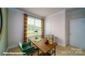 Well lit office featuring a large window with a view, and a modern desk with shelving and a green chair at 121 Sari St, Troutman, NC 28166