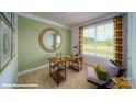 Well lit office featuring a large window with a view, a round mirror, and a modern desk with shelving at 121 Sari St, Troutman, NC 28166