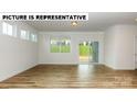 Living area with hardwood floors, sliding glass doors, and large windows at 131 Sari St, Troutman, NC 28166