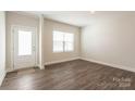 Bright entryway with hardwood floors and white door at 179 Wembury Ln, Troutman, NC 28166
