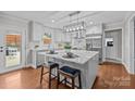 Bright, modern kitchen with white cabinets, stainless steel appliances, and an island with bar seating at 2733 Wellington St, Rock Hill, SC 29732