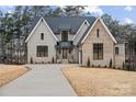 Beautiful new construction home with a large driveway, brick and siding exterior, and manicured landscaping at 4069 Rivendell Rd # 5, Denver, NC 28037