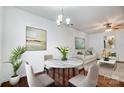 Dining room featuring hardwood floors, modern chandelier, and a round marble table that seats four at 9345 Hamel St, Charlotte, NC 28215