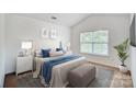 Bedroom featuring neutral paint, a large window, and stylish décor with a padded bench at the foot of the bed at 9345 Hamel St, Charlotte, NC 28215