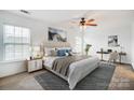Bright main bedroom with ceiling fan, large windows, and a dedicated workspace with a desk and chair at 9345 Hamel St, Charlotte, NC 28215
