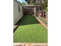 Backyard putting green with artificial turf, bordered by plants, and a wooden frame at 949 Grace Ave, Lancaster, SC 29720