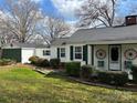 Charming single-story home featuring decorative wagon wheels and well-maintained landscaping at 949 Grace Ave, Lancaster, SC 29720