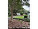 Landscaped front yard of a single-story home with mature trees and a well-kept lawn at 949 Grace Ave, Lancaster, SC 29720