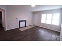 Living room with fireplace and dark brown wood floors at 602 Glenn St, Gastonia, NC 28052