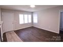 Living room with wood floors, white door and windows at 602 Glenn St, Gastonia, NC 28052