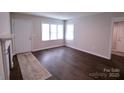 Living room with wood floors, white door and windows at 602 Glenn St, Gastonia, NC 28052