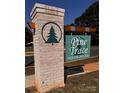 Pine Trace Neighborhood entrance sign featuring brick pillar and green tree logo at 4069 Port Richmond Ave # 16, Gastonia, NC 28056