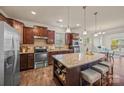 Modern kitchen with stainless steel appliances, granite countertops and a large center island with barstool seating at 984 Kirby Dr, Fort Mill, SC 29715