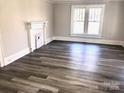 Spacious living room with hardwood floors and a fireplace at 1012 4Th St, Statesville, NC 28677