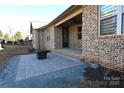 Spacious outdoor patio featuring brickwork and a small black table set on a low maintenance lot at 3778 Rock Bridge Ne Dr, Conover, NC 28613