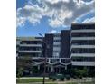 Exterior shot of the building's facade with white lettering and a well-manicured front yard at 1300 Reece Rd # 302, Charlotte, NC 28209