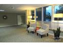 Inviting lobby area with seating, plants, and a view of the exterior at 1300 Reece Rd # 302, Charlotte, NC 28209