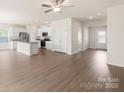 Open kitchen with island, stainless steel appliances, and light wood floors at 3532 Clover Valley Dr, Gastonia, NC 28052