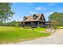 Log cabin home nestled on a spacious lot with lush green grass at 4796 Dewitt Rd, Blackstock, SC 29014