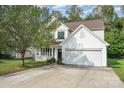 Inviting two-story home with a front porch, well-kept lawn, and a two-car garage at 4741 Nijinsky Ct, Charlotte, NC 28216