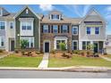 Charming townhome showcases a well-manicured lawn, varied siding, and a welcoming front entrance at 939 Cobbled Way, Fort Mill, SC 29715