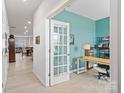 Bright home office with light wood desk and teal walls at 939 Cobbled Way, Fort Mill, SC 29715