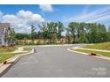 View of a well-maintained street within the community, with sidewalks, landscaping, and community atmosphere at 939 Cobbled Way, Fort Mill, SC 29715