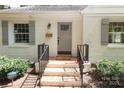 Gray front door with brick steps and gray shutters at 1422 Morningside Dr, Charlotte, NC 28205