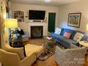 Cozy living room features a fireplace, comfy seating, and hardwood floors at 1422 Morningside Dr, Charlotte, NC 28205