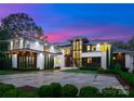Beautiful exterior view of the home, highlighting its contemporary design and manicured front lawn at 2116 Woodhaven Rd, Charlotte, NC 28211