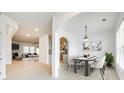 Bright dining room with modern light fixture, arched doorways, and white wood floors at 4023 Home Grown Way, Lake Wylie, SC 29710