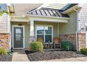 Inviting front porch with rocking chairs and stone accents at 4023 Home Grown Way, Lake Wylie, SC 29710