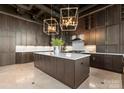 Modern kitchen with dark cabinetry, large island, and high ceilings at 127 Tryon N St # 503, Charlotte, NC 28202