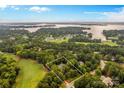 Aerial view of waterfront estate with golf course and lake views, showcasing the property's prime location at 130 Stonewall Beach Ln, Mooresville, NC 28117