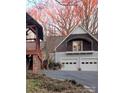 Two-story home with attached garage and gazebo, surrounded by trees at 1409 Trinity Church Rd, Monroe, NC 28112