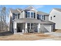 Two-story home with gray siding, stone accents, and a two-car garage at 2040 White Cypress Ct # Kh09, Charlotte, NC 28216