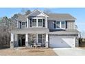 Two-story home with gray siding, stone accents, and a two-car garage at 2040 White Cypress Ct # Kh09, Charlotte, NC 28216