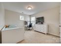 Bright bedroom with a light-colored carpet, a bed, desk, dresser and one window at 16840 Rudence Ct, Charlotte, NC 28278