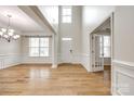 Bright foyer featuring hardwood floors, high ceilings, and elegant wainscoting at 16840 Rudence Ct, Charlotte, NC 28278